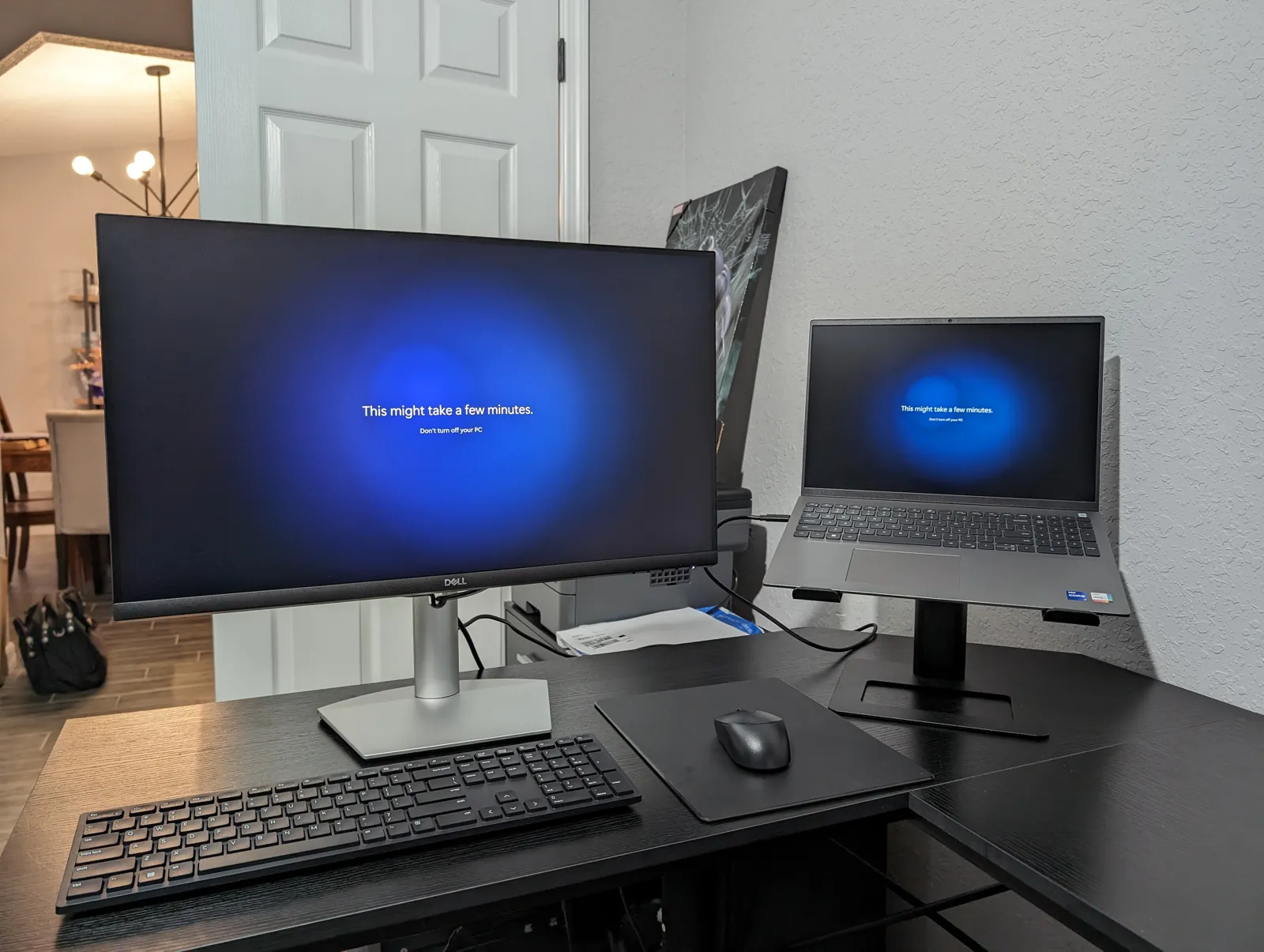 Monitor and laptop set up side by side on a home office desk