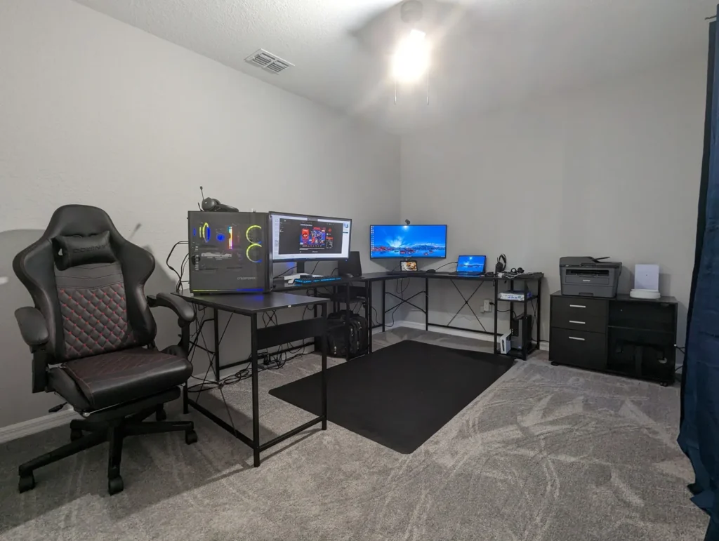 Home office with a desktop computer, laptop, and printer set up and ready to use